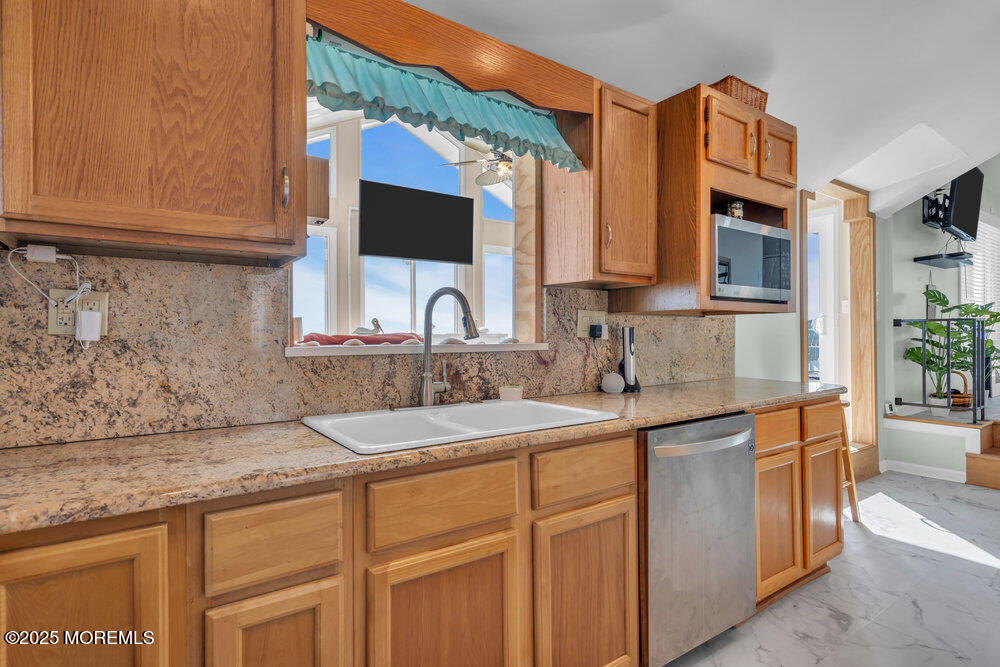 1604 Beach Boulevard Forked River, NJ 08731 - Photo 27 of 108 a kitchen with stainless steel appliances granite countertop a sink stove and cabinets
