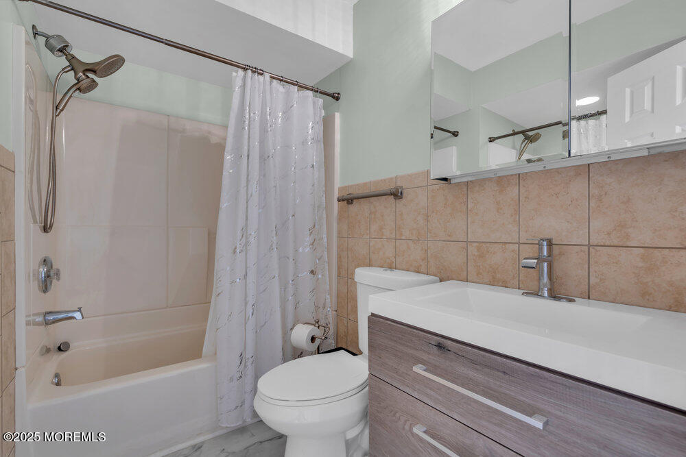 1604 Beach Boulevard Forked River, NJ 08731 - Photo 50 of 108 a bathroom with a sink a toilet a mirror and a shower