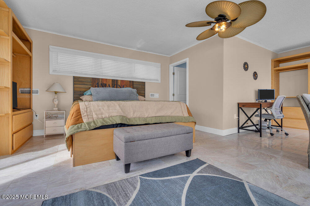 1604 Beach Boulevard Forked River, NJ 08731 - Photo 53 of 108 a bedroom with a bed lamps and chairs