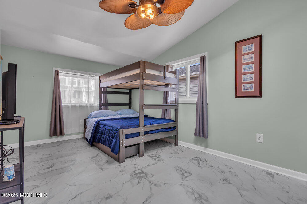 1604 Beach Boulevard Forked River, NJ 08731 - Photo 67 of 108 a bedroom with a bed and a chandelier