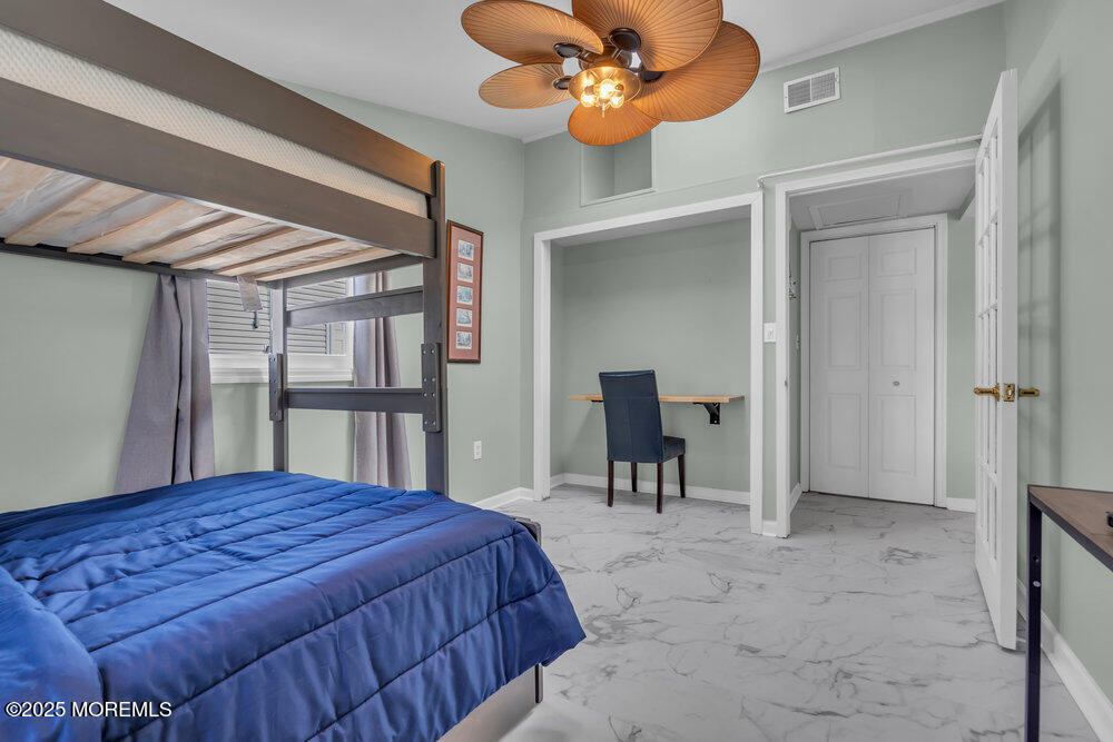 1604 Beach Boulevard Forked River, NJ 08731 - Photo 69 of 108 a bedroom with a bed and a chandelier