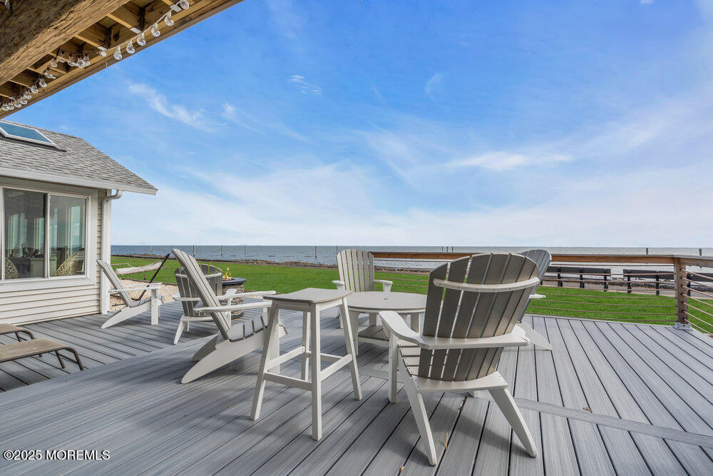 1604 Beach Boulevard Forked River, NJ 08731 - Photo 80 of 108 a patio with lawn chairs and wooden floor