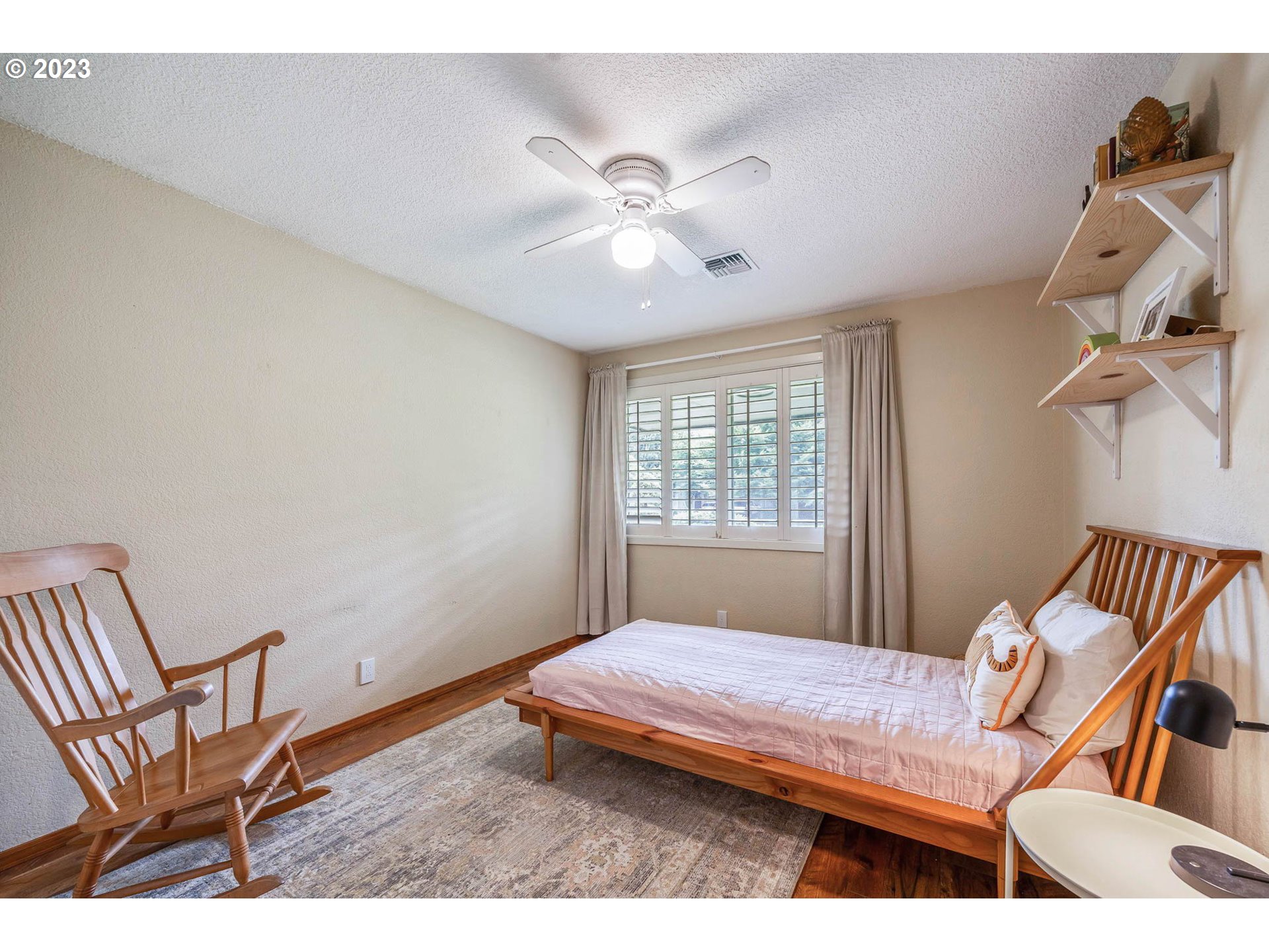 3555 Bardell Avenue Eugene, OR 97401 - Photo 14 of 31 a bedroom with a bed and a chandelier