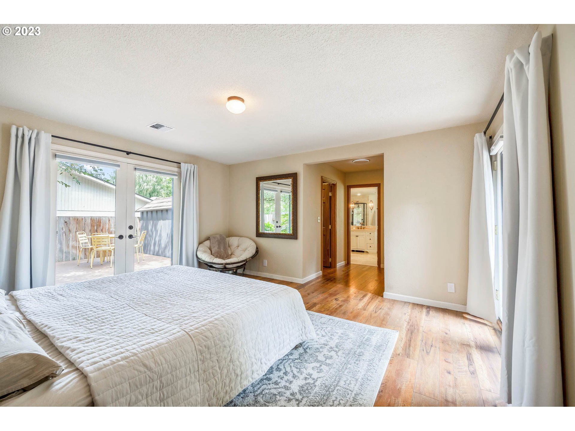 3555 Bardell Avenue Eugene, OR 97401 - Photo 18 of 31 a bedroom with a large bed and wooden floor