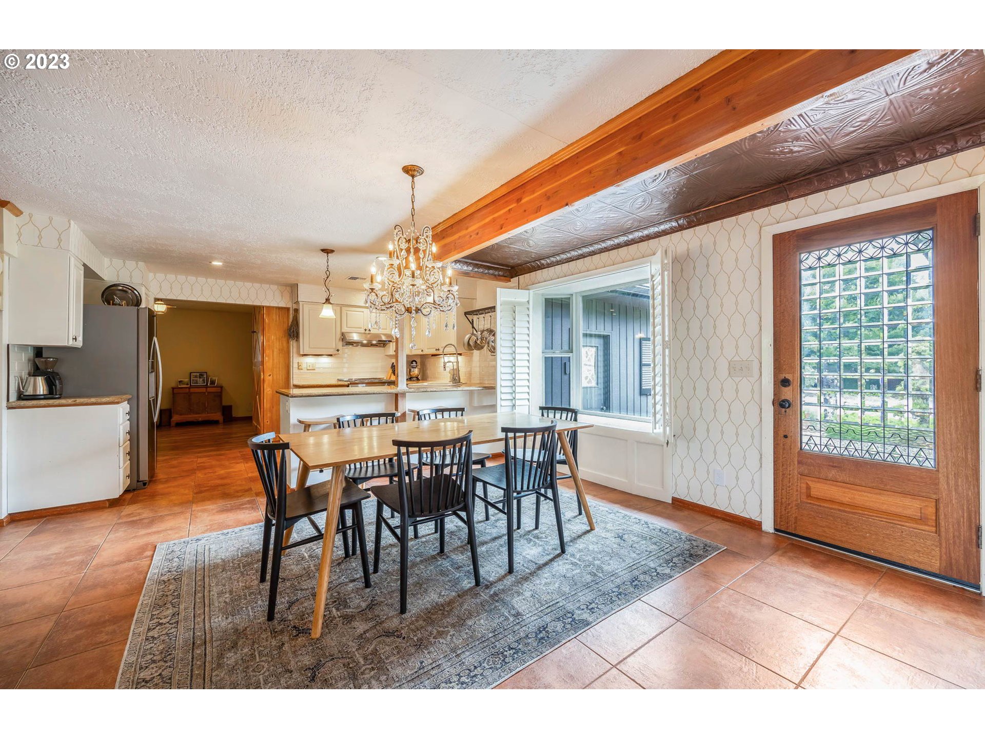 3555 Bardell Avenue Eugene, OR 97401 - Photo 3 of 31 a dining room with furniture a chandelier and wooden floor