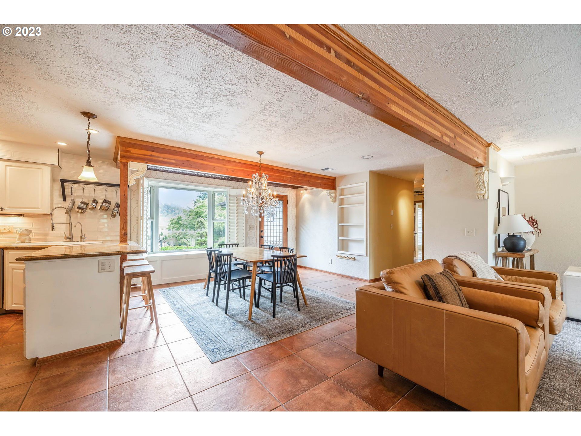 3555 Bardell Avenue Eugene, OR 97401 - Photo 7 of 31 a living room with furniture a wooden floor and a large window