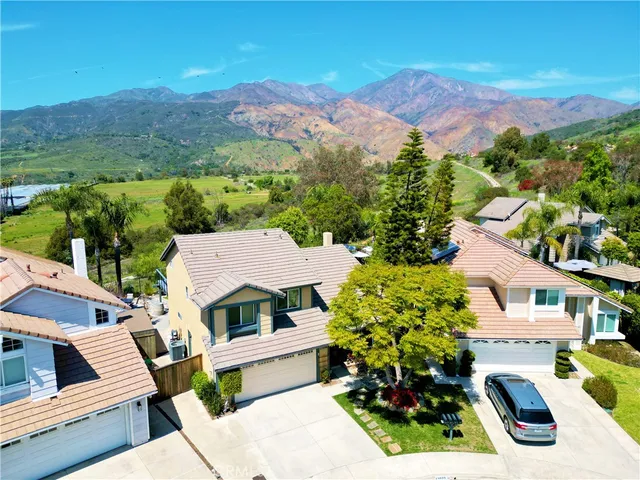 an aerial view of multiple houses with a yard
