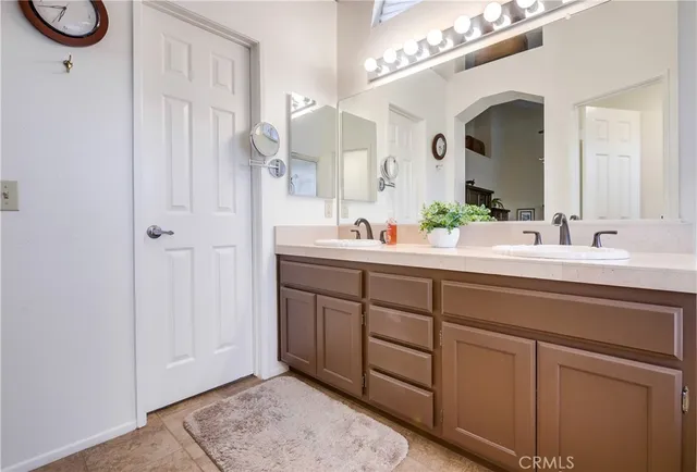 a bathroom with a sink vanity and a mirror