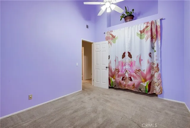 a living room with furniture ceiling fan and a window