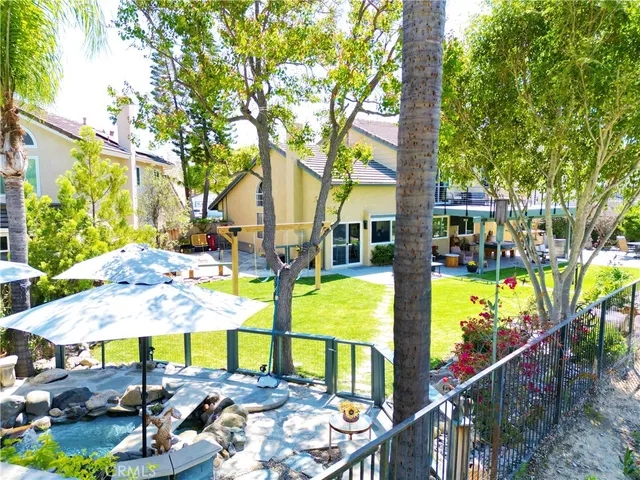 a view of a patio with a table and chairs under an umbrella
