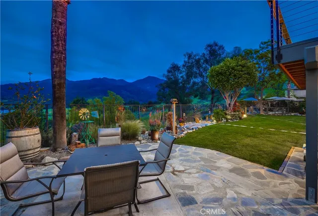 a view of a house with a yard and palm tree