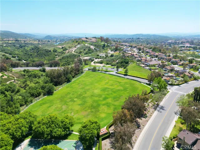 an aerial view of residential houses with outdoor space and street view