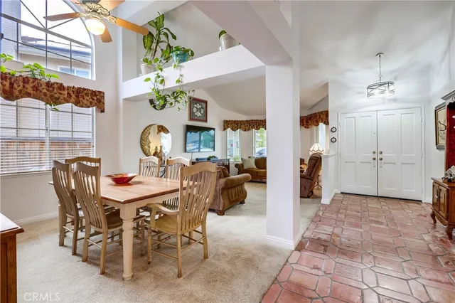 a living room with furniture a fireplace a rug and a large window