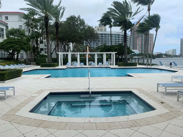 a view of swimming pool with outdoor seating and plants