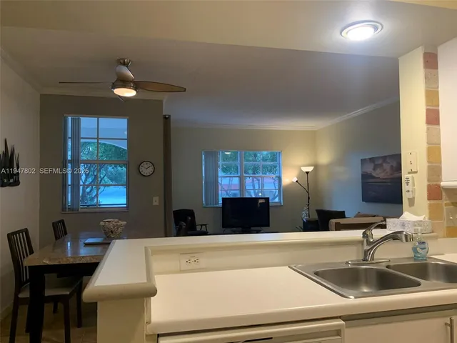 a kitchen with a sink cabinets and a large window