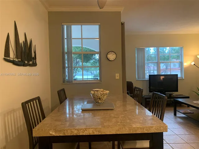 a view of a dining room with furniture and a window