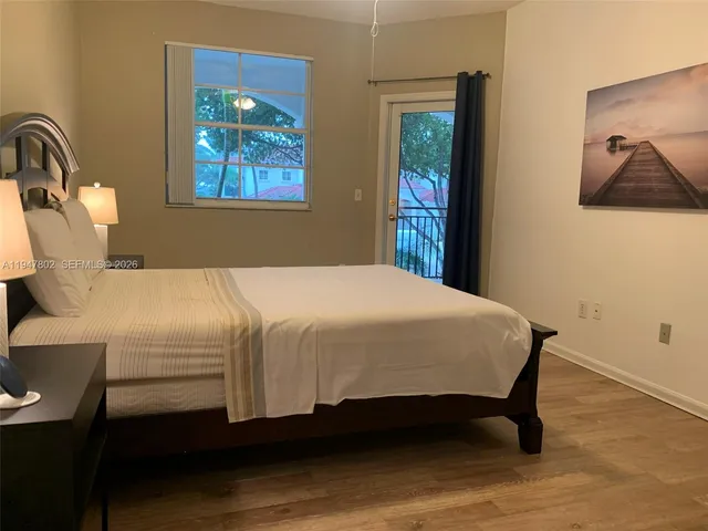a bedroom with a bed and a painting on the wall