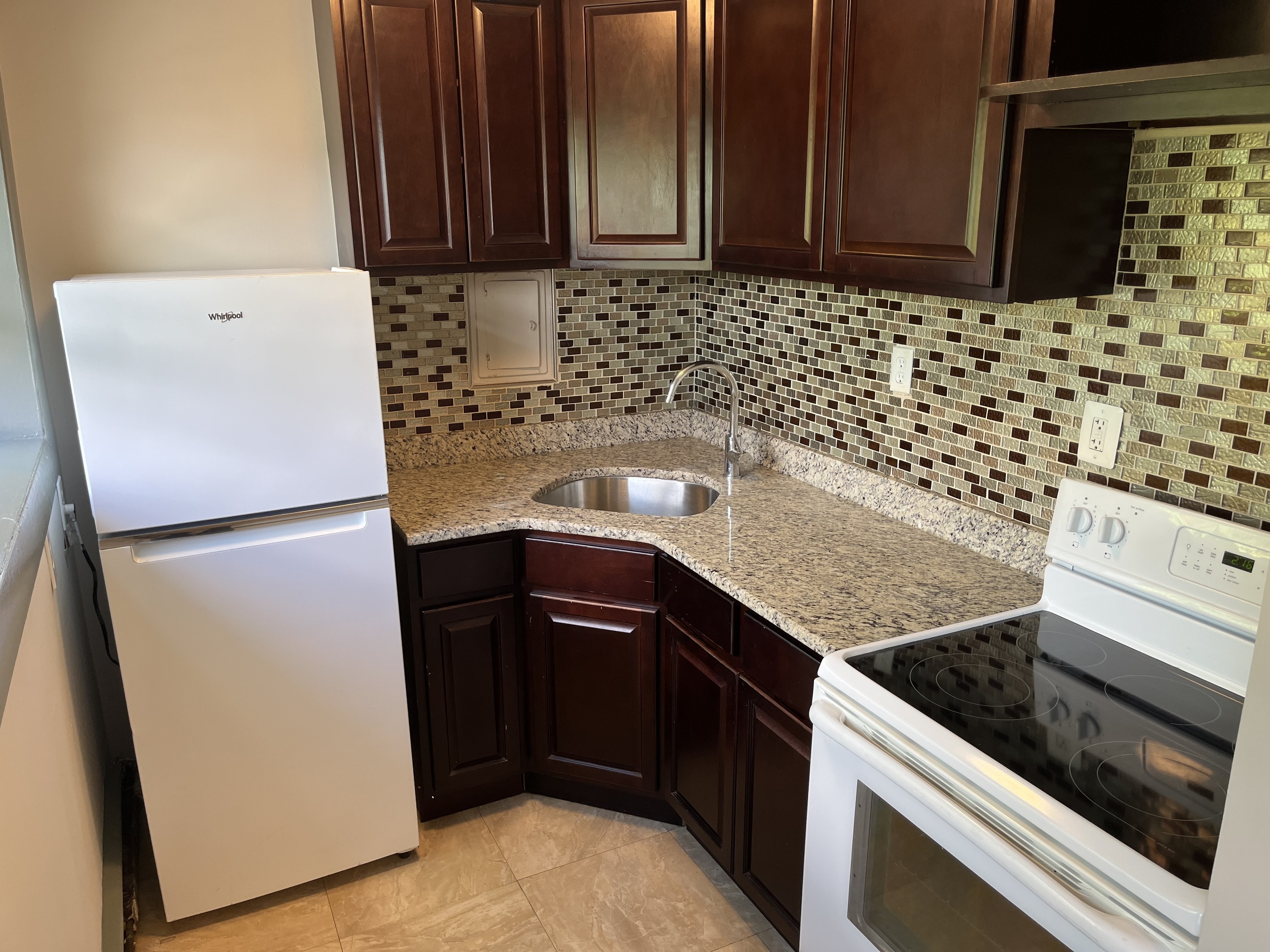 32 Cook Avenue, Unit 306 Meriden, CT 06451 - Photo 4 of 9 a kitchen with a sink stove and cabinets