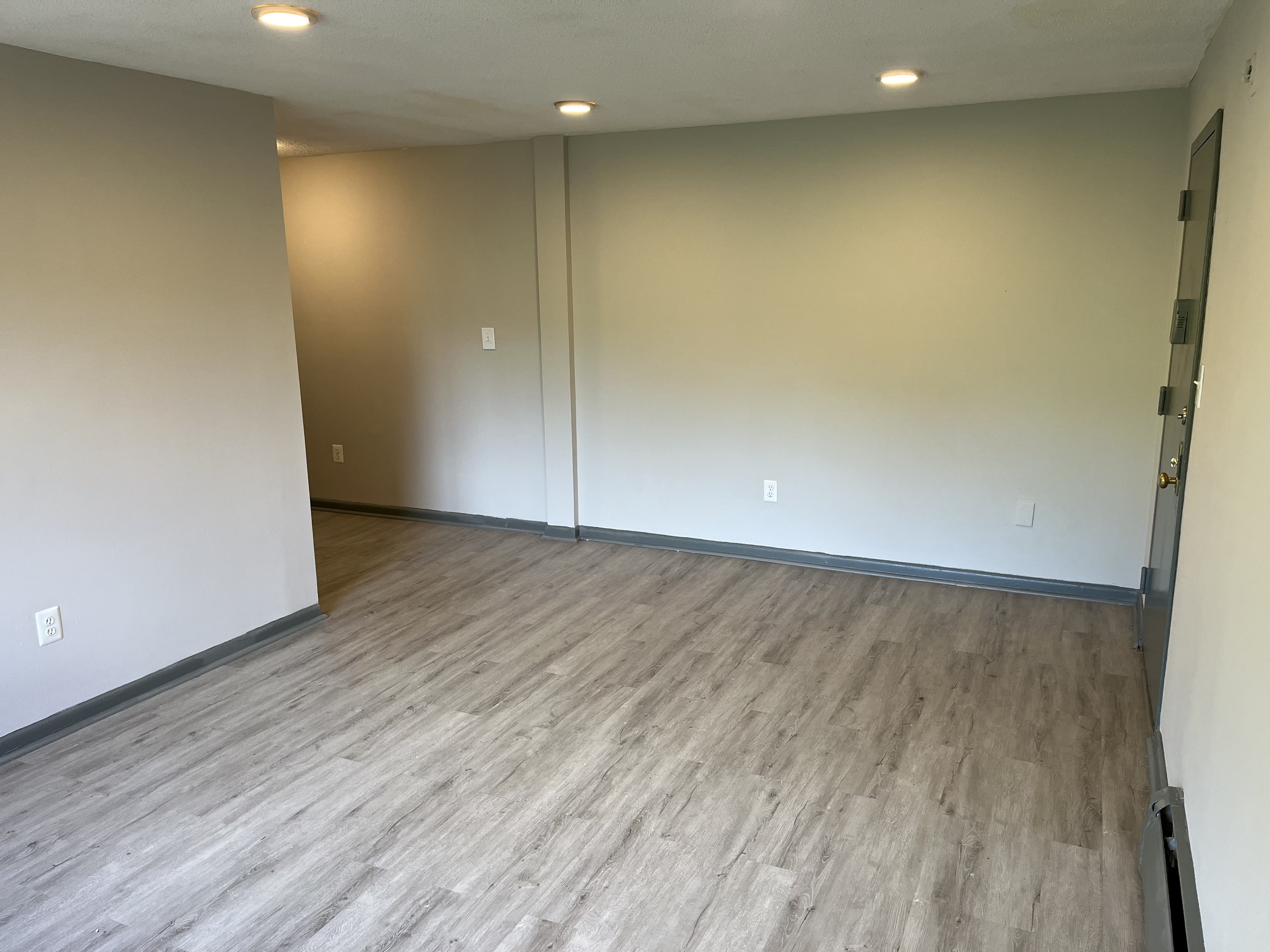 32 Cook Avenue, Unit 306 Meriden, CT 06451 - Photo 6 of 9 an empty room with wooden floor and windows