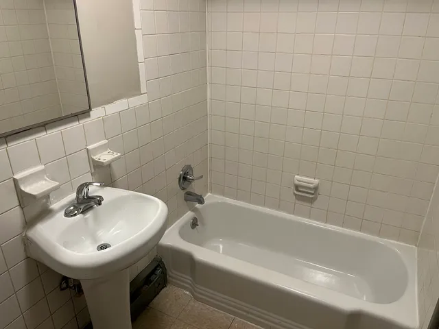 a white bath tub sitting next to a white sink