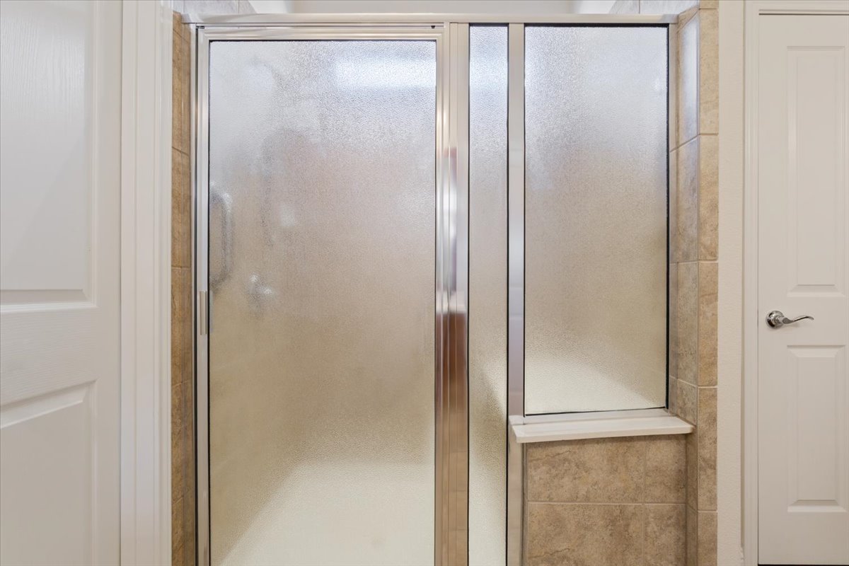 108 Cathedral Mountain Pass Georgetown, TX 78633 - Photo 23 of 36 a bathroom with a glass shower door