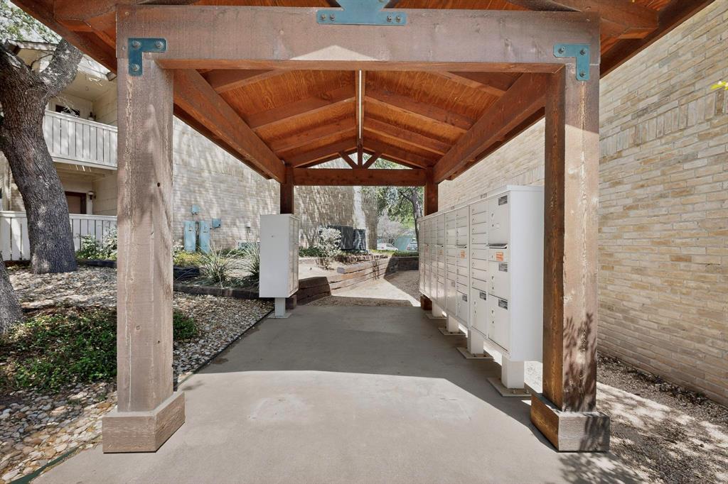 8210 Bent Tree Road, Unit 116 Austin, TX 78759 - Photo 13 of 21 A sturdy timber pavilion covers the community mailbox area set against masonry walls.