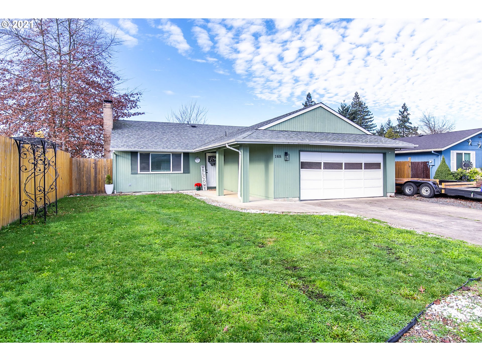 168 North 38th Place Springfield, OR 97478 - Photo 1 of 19 a front view of a house with a garden and trees