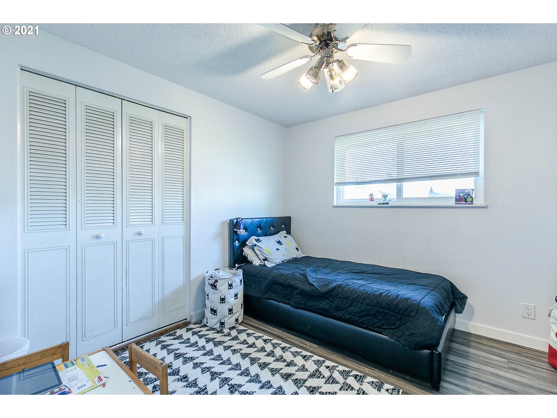 168 North 38th Place Springfield, OR 97478 - Photo 13 of 19 a bedroom with a bed and a chandelier