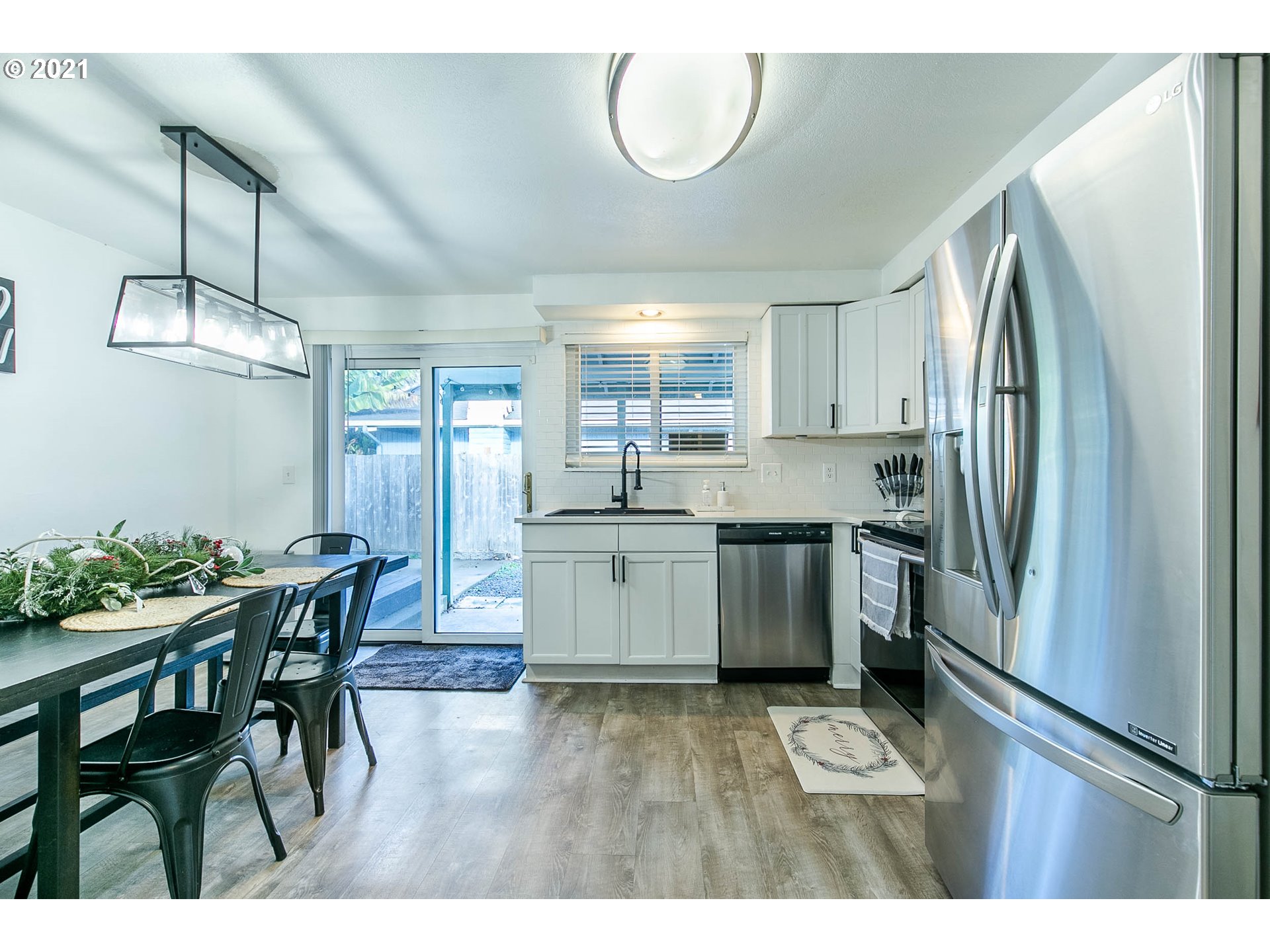 168 North 38th Place Springfield, OR 97478 - Photo 6 of 19 a kitchen with a table chairs refrigerator and microwave