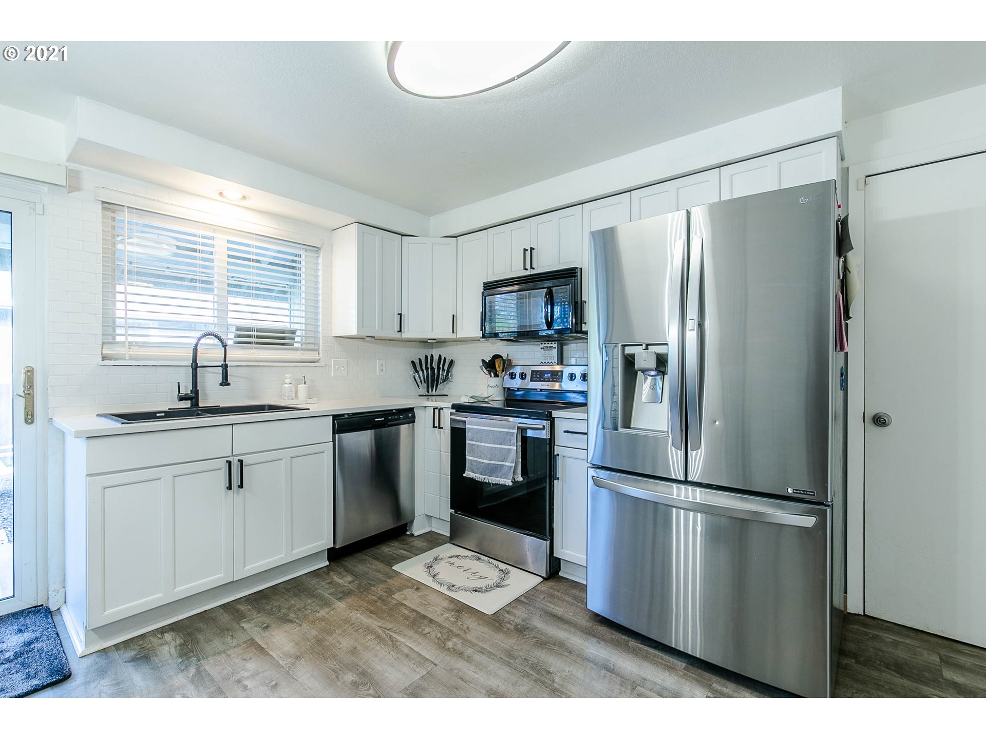 168 North 38th Place Springfield, OR 97478 - Photo 9 of 19 a kitchen with a refrigerator a sink stainless steel appliances and cabinets