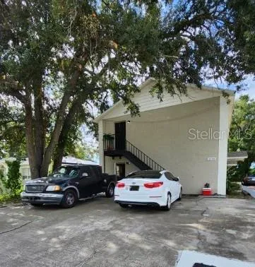 a view of cars parked in front of a house
