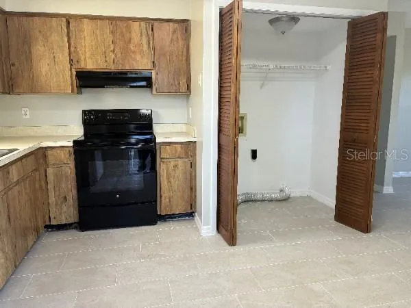 a kitchen with a refrigerator and a stove