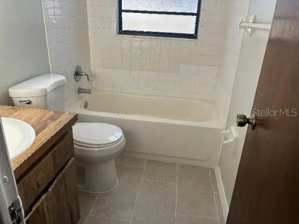 a white toilet sitting next to a bathroom sink