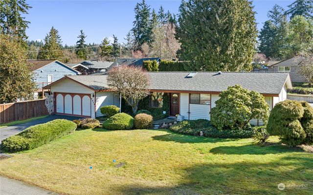 a view of a house with a yard and potted plants