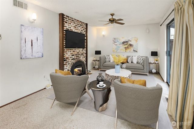 a view of empty room with fireplace and windows
