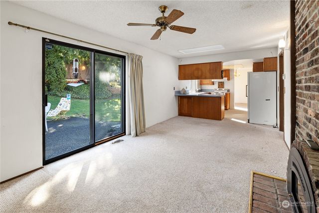 a kitchen with stainless steel appliances granite countertop a sink and a refrigerator