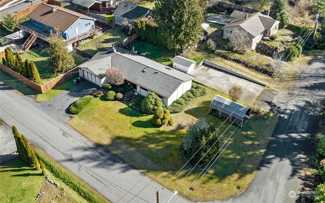 an aerial view of a house with a yard and potted plants