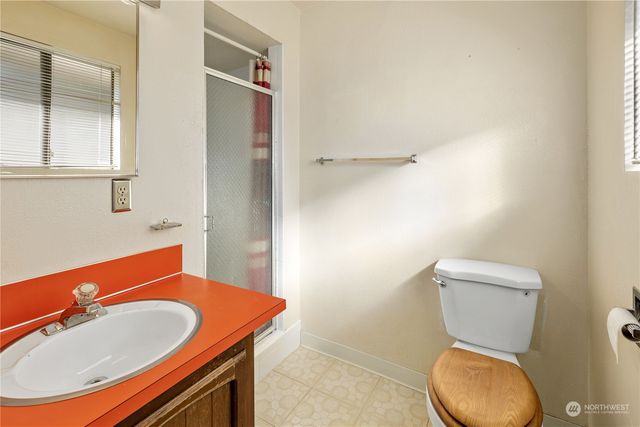 a view of a room with wooden floor and windows