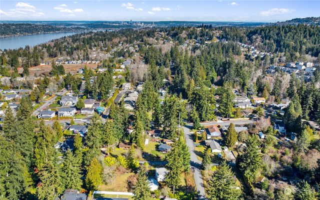 an aerial view of a residential houses with yard