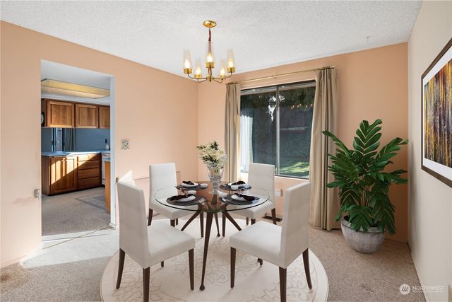 a view of a dining room with furniture and window