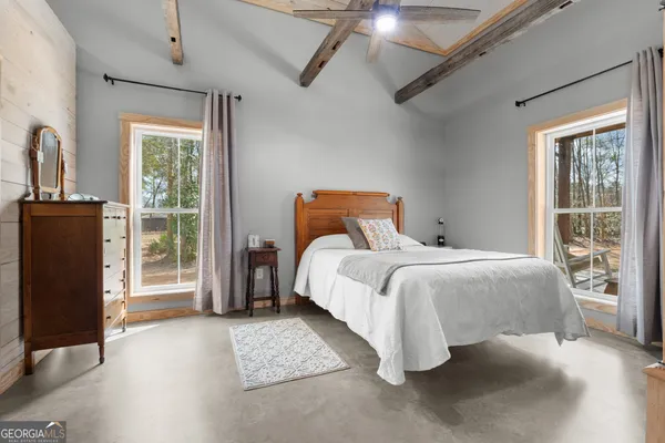 a bedroom with a large bed and a large window