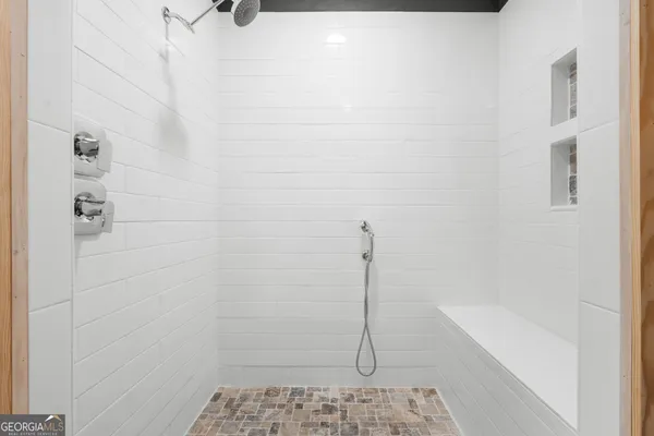 a bedroom with a bed and a shower