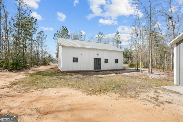 a view of a white house with a yard
