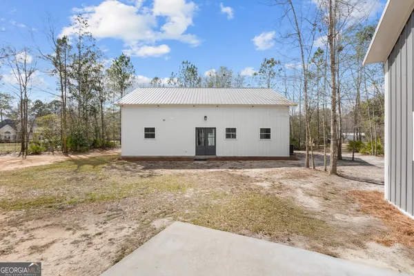 a view of a house with a yard and garage