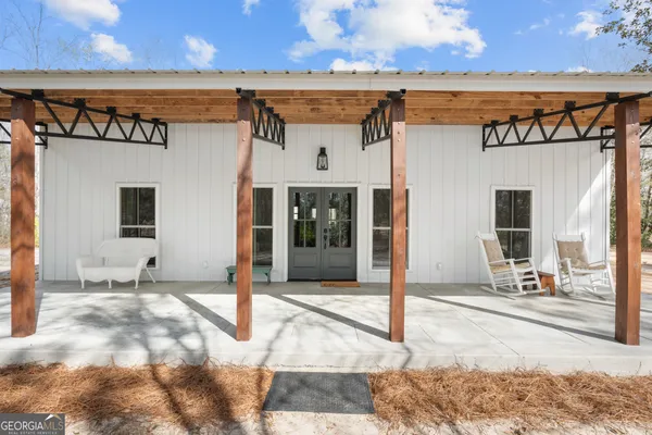 a living room with furniture and kitchen view
