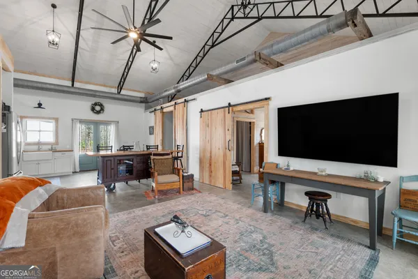 a kitchen with a table chairs refrigerator and cabinets