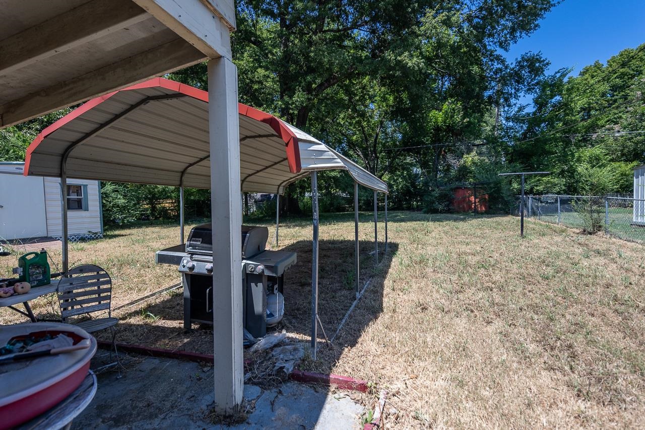 5080 Sea Isle Road Memphis, TN 38117 - Photo 6 of 21 a backyard of a house with barbeque oven table and chairs