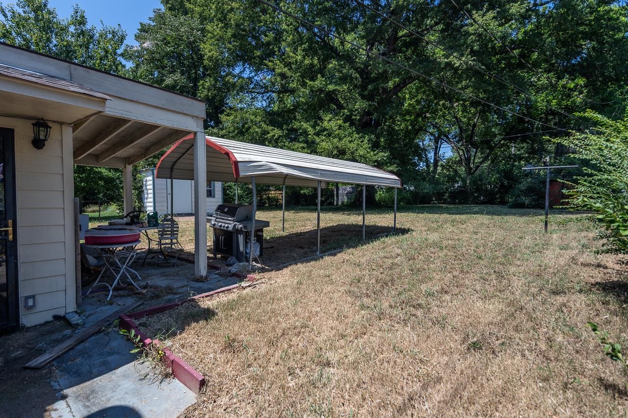 5080 Sea Isle Road Memphis, TN 38117 - Photo 7 of 21 a view of a patio with table and chairs under an umbrella