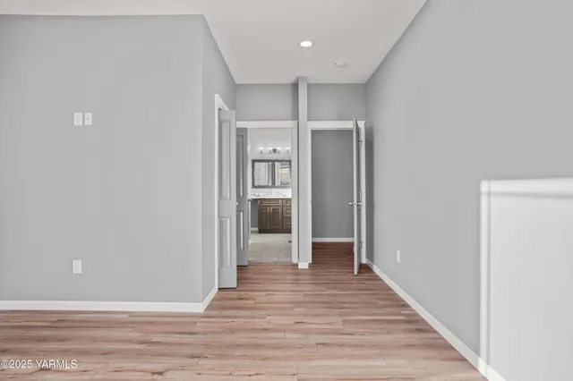 a view of a hallway with wooden floor