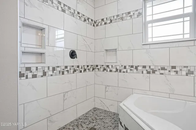 a bathroom with a bathtub and a shower